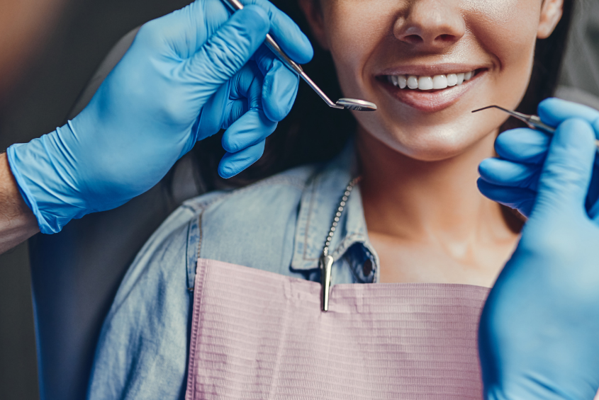 A dentist preparing a patient’s teeth for dental veneers in a modern Turkish clinic.